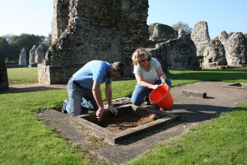 Will Fletcher (English Heritage) and Jackie Hall (project archaeologist) investigating entry to the 1524 vault. The top of the hatch is filled with sand